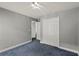 Cozy bedroom with closet, neutral walls, carpet flooring and doorway view into hall at 5580 Berwood Dr, Orlando, FL 32810