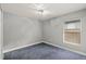 Cozy bedroom featuring neutral walls, carpet flooring, and a window with blinds at 5580 Berwood Dr, Orlando, FL 32810