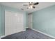 Comfortable bedroom featuring neutral walls, carpet flooring, closet and fan with lighting at 5580 Berwood Dr, Orlando, FL 32810