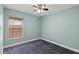 Comfortable bedroom featuring neutral walls, carpet flooring, a window with blinds and fan at 5580 Berwood Dr, Orlando, FL 32810