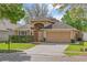 Inviting single-Gathering home with well-maintained landscaping and a spacious driveway at 5580 Berwood Dr, Orlando, FL 32810