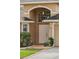 Close up front entrance of house with decorative landscape, and arched entryway at 5580 Berwood Dr, Orlando, FL 32810