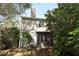 Back exterior view of house with sunroom and landscaping at 559 Northbridge Dr, Altamonte Springs, FL 32714
