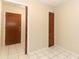 Hallway features white tiled floors, a closet, and neutral colored walls at 559 Northbridge Dr, Altamonte Springs, FL 32714