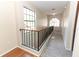 Hallway with railing, large windows, and carpet at 559 Northbridge Dr, Altamonte Springs, FL 32714