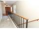 Second floor hallway features carpet floors and a wrought-iron staircase at 559 Northbridge Dr, Altamonte Springs, FL 32714