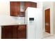 Modern kitchen with granite countertops, wood cabinets, and a view into an adjacent room at 559 Northbridge Dr, Altamonte Springs, FL 32714