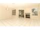 Bright living room featuring tiled floors, a cozy fireplace, and access to a screened-in porch at 559 Northbridge Dr, Altamonte Springs, FL 32714