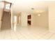 Open-concept living space featuring tiled floors, a staircase, and views into the kitchen at 559 Northbridge Dr, Altamonte Springs, FL 32714