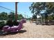 Community playground featuring a dinosaur spring rider, swings, slide, and climbing structure at 559 Northbridge Dr, Altamonte Springs, FL 32714