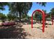 Community playground featuring a spinning merry-go-round, swings, and a climbing structure on a mulch surface at 559 Northbridge Dr, Altamonte Springs, FL 32714