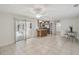 Open floor plan with tile floors, neutral paint, view to lanai and access to kitchen at 633 London Rd, Winter Park, FL 32792