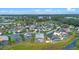 Aerial view of neighborhood showcasing the community's screened in pools, water, and landscaping at 647 Ella Mae Dr, Davenport, FL 33897