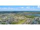 Scenic aerial perspective of a neighborhood with water features, golf course, and verdant trees at 647 Ella Mae Dr, Davenport, FL 33897