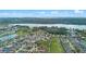Community aerial shot showcasing a pond, green space, and homes surrounded by natural beauty at 647 Ella Mae Dr, Davenport, FL 33897