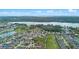 Aerial view of community surrounded by trees, a lake and golf course at 647 Ella Mae Dr, Davenport, FL 33897
