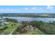 Stunning aerial view showcasing the property's lakefront location, lush landscaping, and community amenities at 647 Ella Mae Dr, Davenport, FL 33897