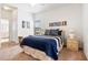 Comfortable bedroom with a blue and white striped bedspread and adjoining bathroom at 647 Ella Mae Dr, Davenport, FL 33897