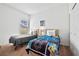 Bright bedroom with two beds, soft carpet, and a window providing natural light at 647 Ella Mae Dr, Davenport, FL 33897