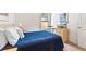 Comfortable bedroom with a blue bedspread, window, and a dresser with a TV on top at 647 Ella Mae Dr, Davenport, FL 33897