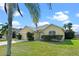 Charming home with a well-manicured lawn and attached two-car garage at 647 Ella Mae Dr, Davenport, FL 33897