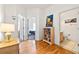 Hallway leading to the bedrooms, featuring nice wooden floors and a decorative bookshelf at 647 Ella Mae Dr, Davenport, FL 33897
