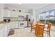 Eat-in kitchen featuring tiled floors, stainless steel appliances, and natural light at 647 Ella Mae Dr, Davenport, FL 33897