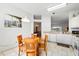 Bright eat-in kitchen with tiled floors and views into the dining and living areas at 647 Ella Mae Dr, Davenport, FL 33897