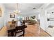 Open-concept living area with hardwood floors, chandelier, and lots of seating at 647 Ella Mae Dr, Davenport, FL 33897
