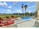 Enjoy this sparkling screened-in pool with lounge chairs for relaxing on sunny days at 647 Ella Mae Dr, Davenport, FL 33897