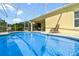 Screened-in outdoor pool area perfect for relaxation and enjoyment on a sunny day at 647 Ella Mae Dr, Davenport, FL 33897