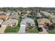 Aerial view of homes in the community, featuring manicured lawns and mature trees at 7233 Se 171St Pond Ln, The Villages, FL 32162
