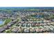 Aerial view of the neighborhood, featuring a large lake and golf course in the distance at 7233 Se 171St Pond Ln, The Villages, FL 32162