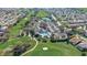 Aerial view of golf course and community center with pool, tennis courts and parking at 7233 Se 171St Pond Ln, The Villages, FL 32162