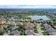 Aerial view of the neighborhood, featuring a large lake and golf course in the distance at 7233 Se 171St Pond Ln, The Villages, FL 32162