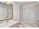 Well-lit bathroom featuring a combination bathtub and shower at 7233 Se 171St Pond Ln, The Villages, FL 32162