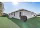 Side of home featuring green lawn at 7233 Se 171St Pond Ln, The Villages, FL 32162