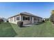 Back of home featuring verdant lawn at 7233 Se 171St Pond Ln, The Villages, FL 32162