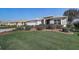 Single-story home boasts manicured lawn, garden beds, and an attached two-car garage at 7233 Se 171St Pond Ln, The Villages, FL 32162