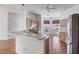 Open-concept kitchen featuring tile flooring, a breakfast bar, and an adjacent dining area at 7233 Se 171St Ln, The Villages, FL 32162