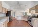 Open kitchen with stainless steel appliances, tile flooring, and light wood cabinets at 7233 Se 171St Pond Ln, The Villages, FL 32162