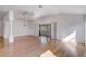 Bright living room featuring hardwood floors, a ceiling fan, and sliding doors leading to outdoor space at 7233 Se 171St Pond Ln, The Villages, FL 32162