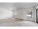 A bright bedroom with neutral carpeting and two windows offering natural light at 7233 Se 171St Pond Ln, The Villages, FL 32162