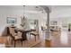 Bright living room features hardwood floors, a modern chandelier, and seamlessly connects to a dining area at 7233 Se 171St Pond Ln, The Villages, FL 32162