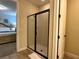 Bright bathroom featuring a glass shower enclosure and neutral tile flooring at 7668 Wilmington Loop, Kissimmee, FL 34747