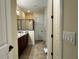 Spacious bathroom with a glass-enclosed shower, granite countertops, and dual vanity at 7668 Wilmington Loop, Kissimmee, FL 34747