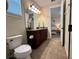 Bathroom featuring granite vanity, large mirror, and tile floors at 7668 Wilmington Loop, Kissimmee, FL 34747