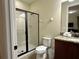 Bathroom with a sleek glass shower, granite countertops, and a modern design at 7668 Wilmington Loop, Kissimmee, FL 34747