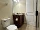 Neat bathroom featuring a toilet, modern vanity, and tiled floors at 7668 Wilmington Loop, Kissimmee, FL 34747