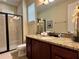 Bathroom showcasing a granite vanity and a glass-enclosed shower at 7668 Wilmington Loop, Kissimmee, FL 34747